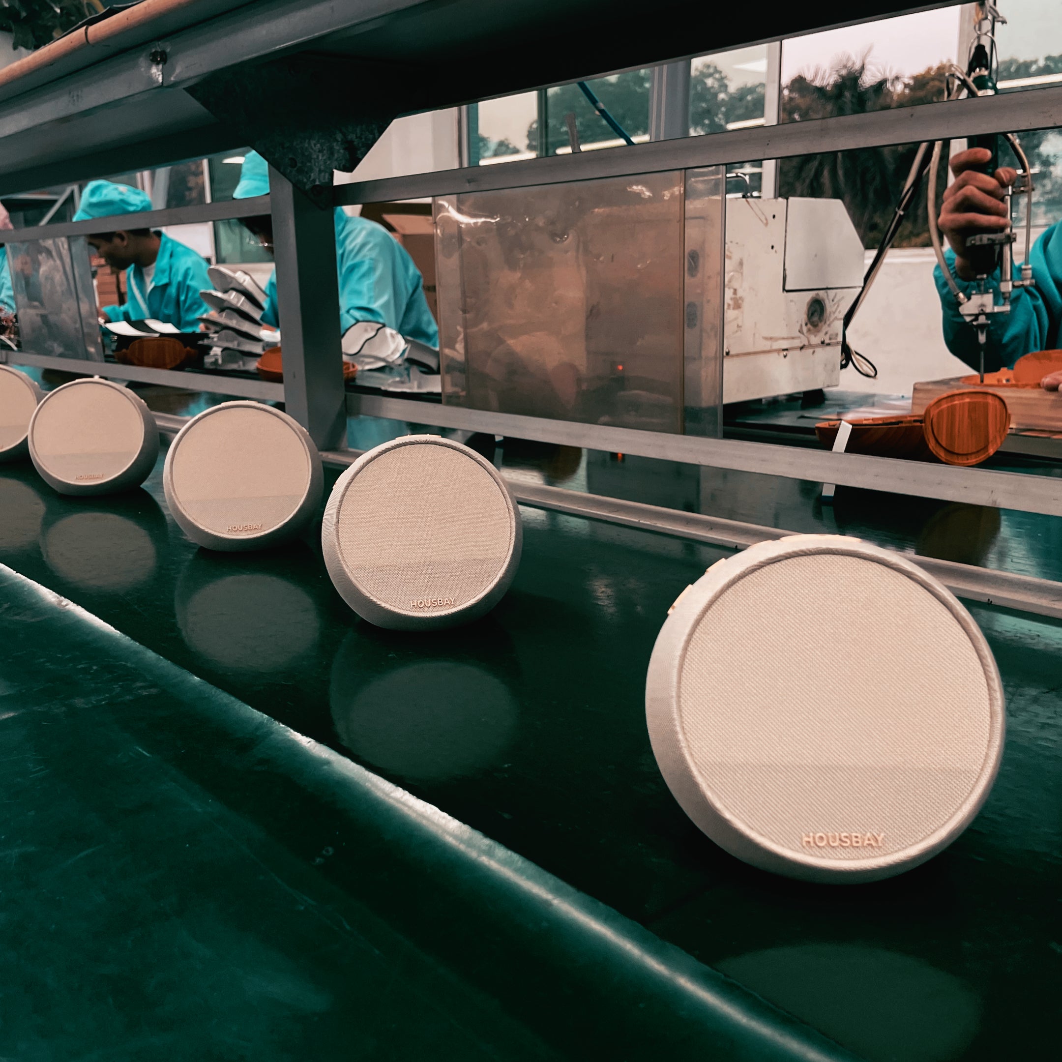 Assembled HOUSBAY MINI units moving in an organized line along the factory conveyor belt during the production process.
