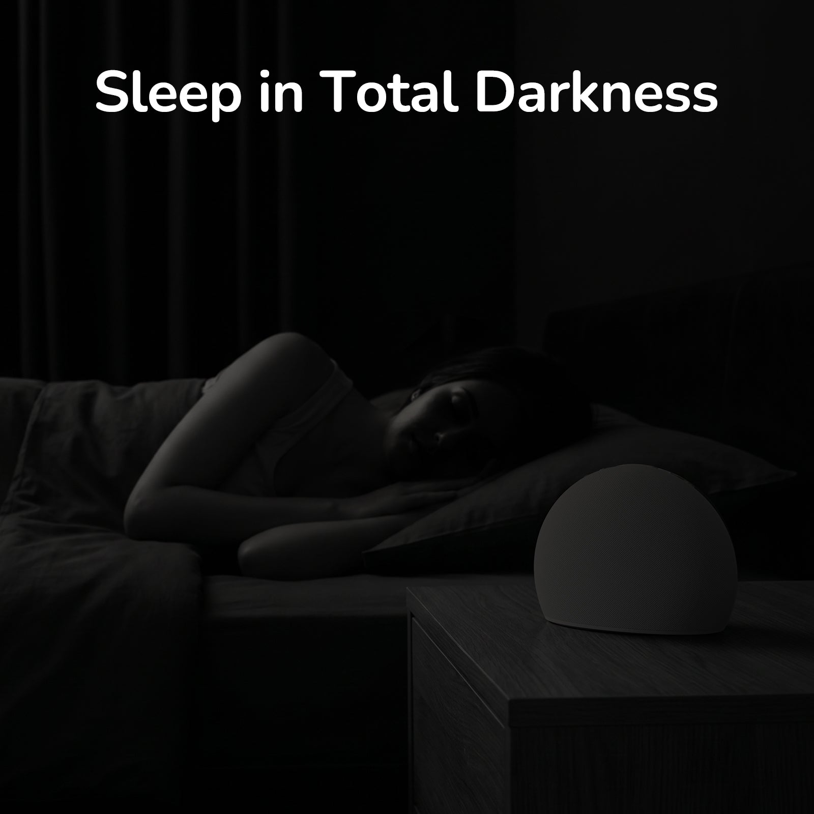A woman sleeping in a completely dark bedroom with the Housbay Dawn smart alarm clock display and lights fully turned off for a night of undisturbed rest.