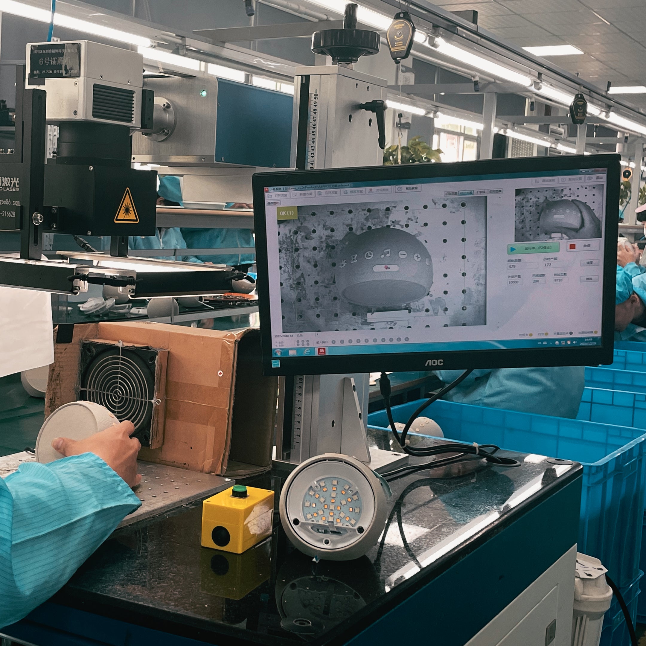 A technician at a professional workstation performing functional tests on the assembled unit against data displayed on a computer screen.